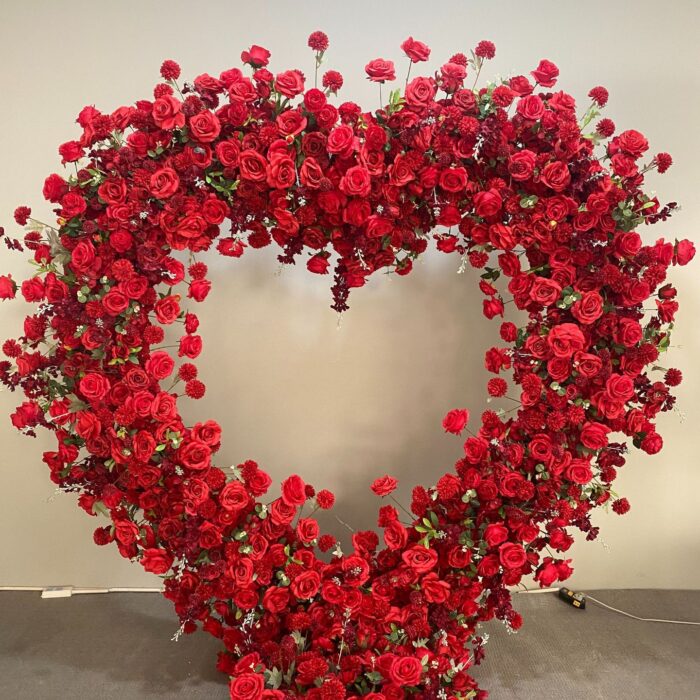 Luxurious Heart-Shaped Arch with Bold Red Roses and Greenery for a Majestic Wedding Backdrop
