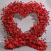 Luxurious Heart-Shaped Arch with Bold Red Roses and Greenery for a Majestic Wedding Backdrop