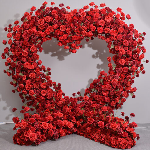 Luxurious Heart-Shaped Arch with Bold Red Roses and Greenery for a Majestic Wedding Backdrop