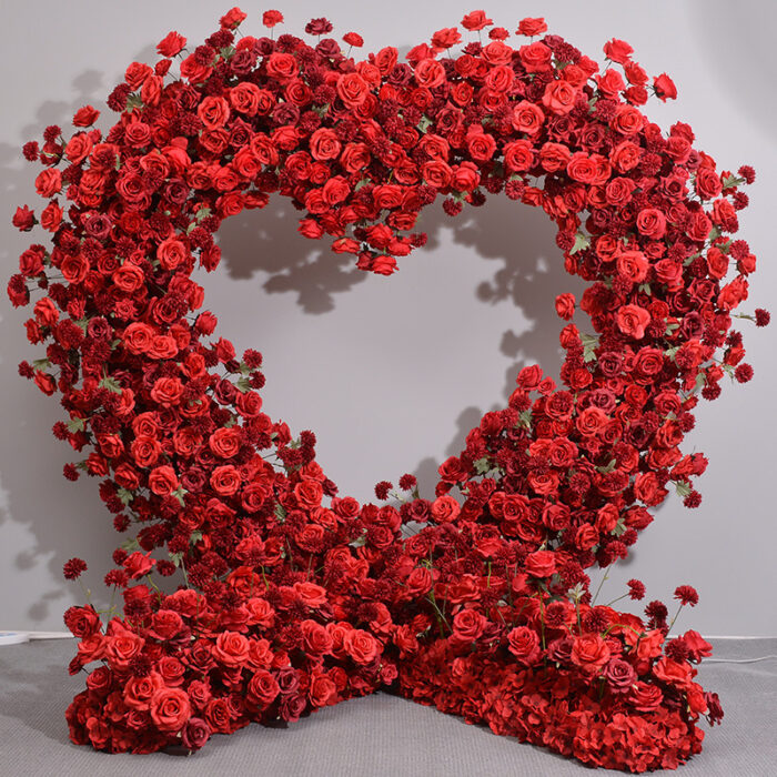 Luxurious Heart-Shaped Arch with Bold Red Roses and Greenery for a Majestic Wedding Backdrop