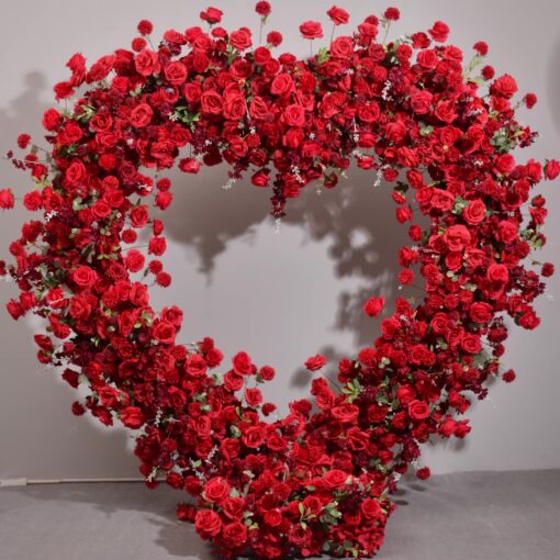 Luxurious Heart-Shaped Arch with Bold Red Roses and Greenery for a Majestic Wedding Backdrop