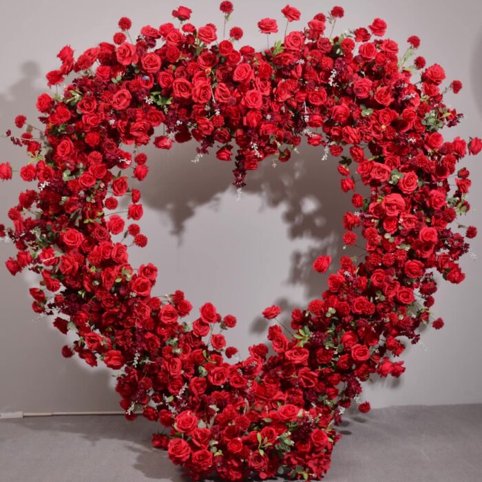 Luxurious Heart-Shaped Arch with Bold Red Roses and Greenery for a Majestic Wedding Backdrop
