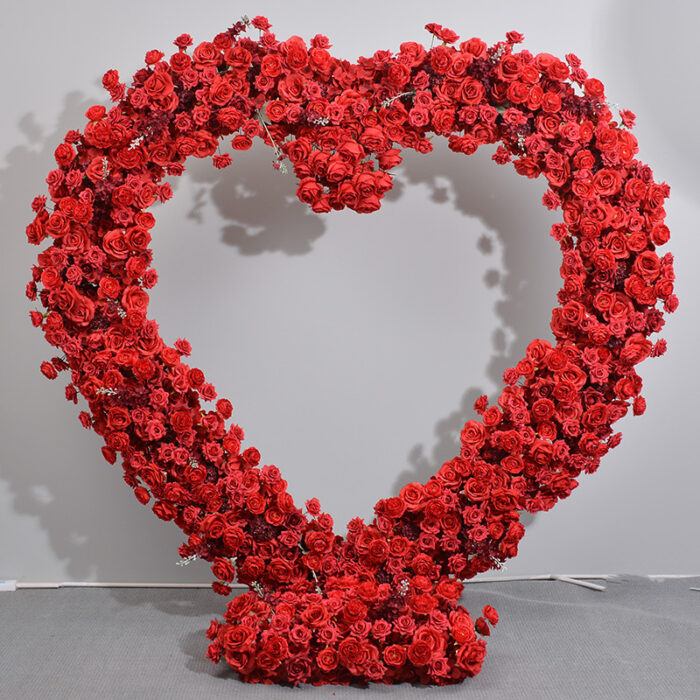 Luxurious Heart-Shaped Arch with Bold Red Roses and Greenery for a Majestic Wedding Backdrop