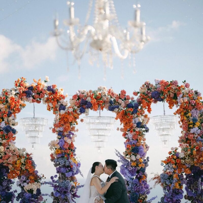 Outdoor Bohemian Wedding in Bali: Colorful Orange and Purple Arches with Floral Touch