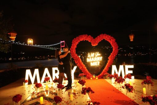 Red Rose Backdrop and Heart Arch for a Heartfelt Proposal Moment