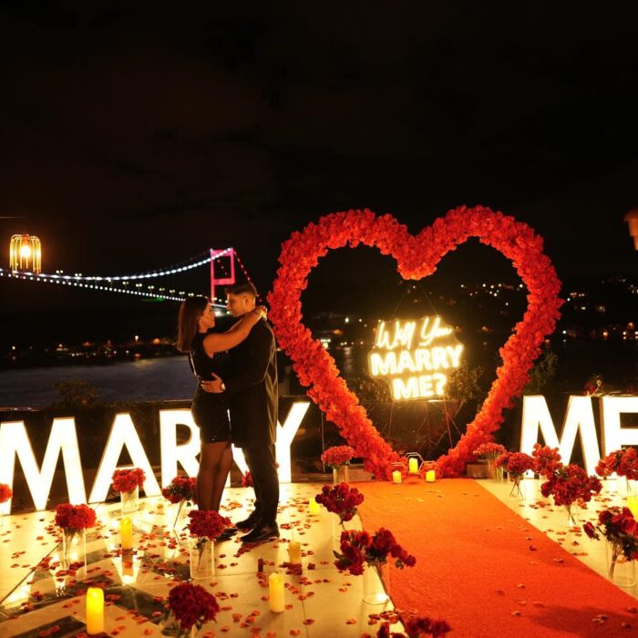 Red Rose Backdrop and Heart Arch for a Heartfelt Proposal Moment