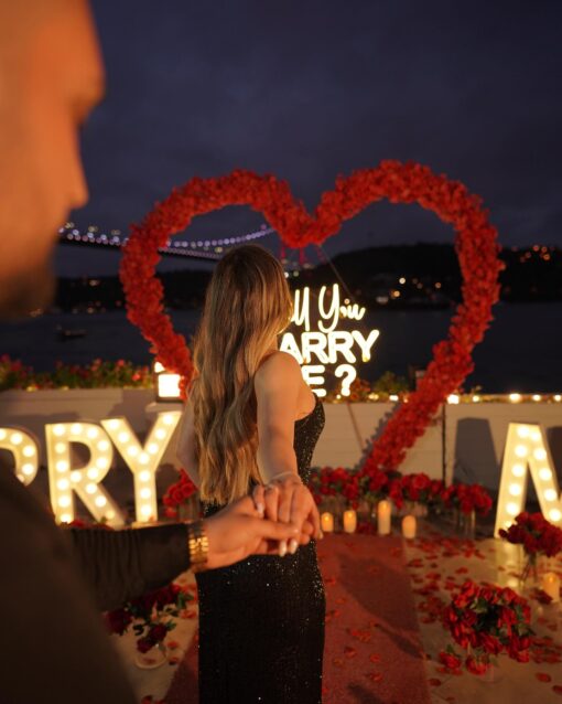 Red Rose Backdrop and Heart Arch for a Heartfelt Proposal Moment