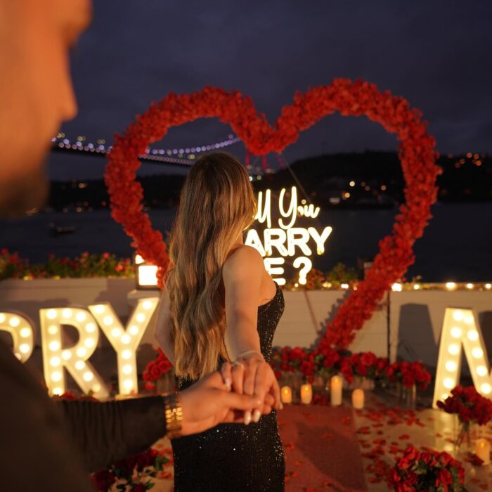 Red Rose Backdrop and Heart Arch for a Heartfelt Proposal Moment