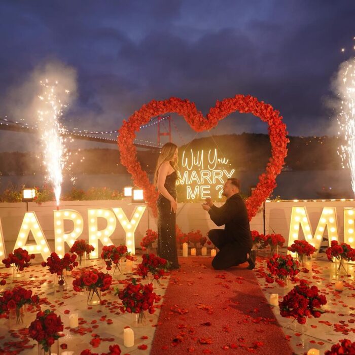 Red Rose Backdrop and Heart Arch for a Heartfelt Proposal Moment