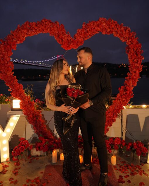Red Rose Backdrop and Heart Arch for a Heartfelt Proposal Moment