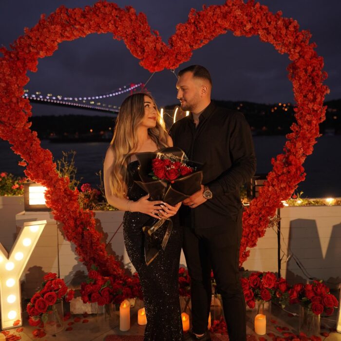 Red Rose Backdrop and Heart Arch for a Heartfelt Proposal Moment