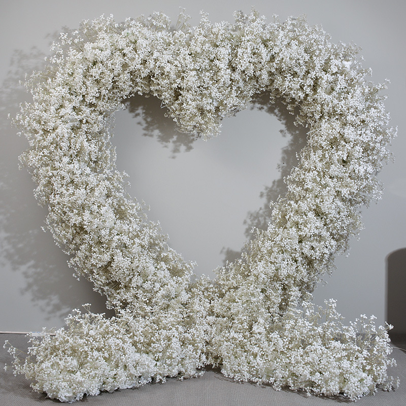 Serene Heart-Shaped Wedding Arch with Baby’s Breath for Tranquil Event Backdrop