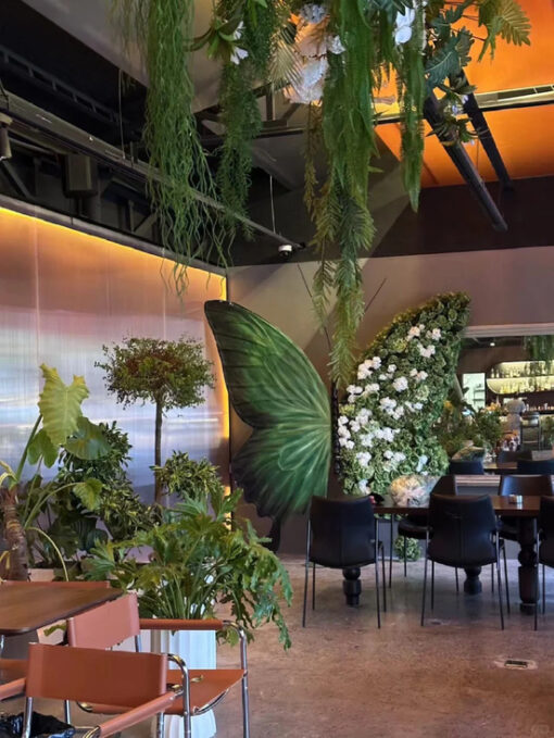 Sophisticated Green Butterfly Backdrop with White Artificial Floral Arrangements for Events
