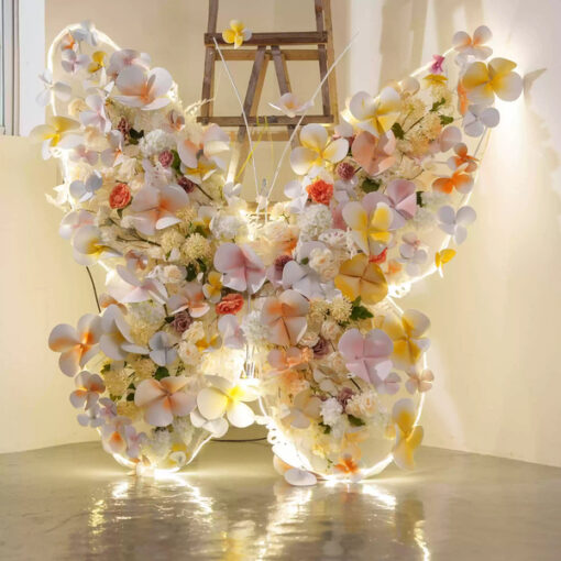 Sophisticated Warm Tone Butterfly Backdrop with Artificial Flowers and LED Elements