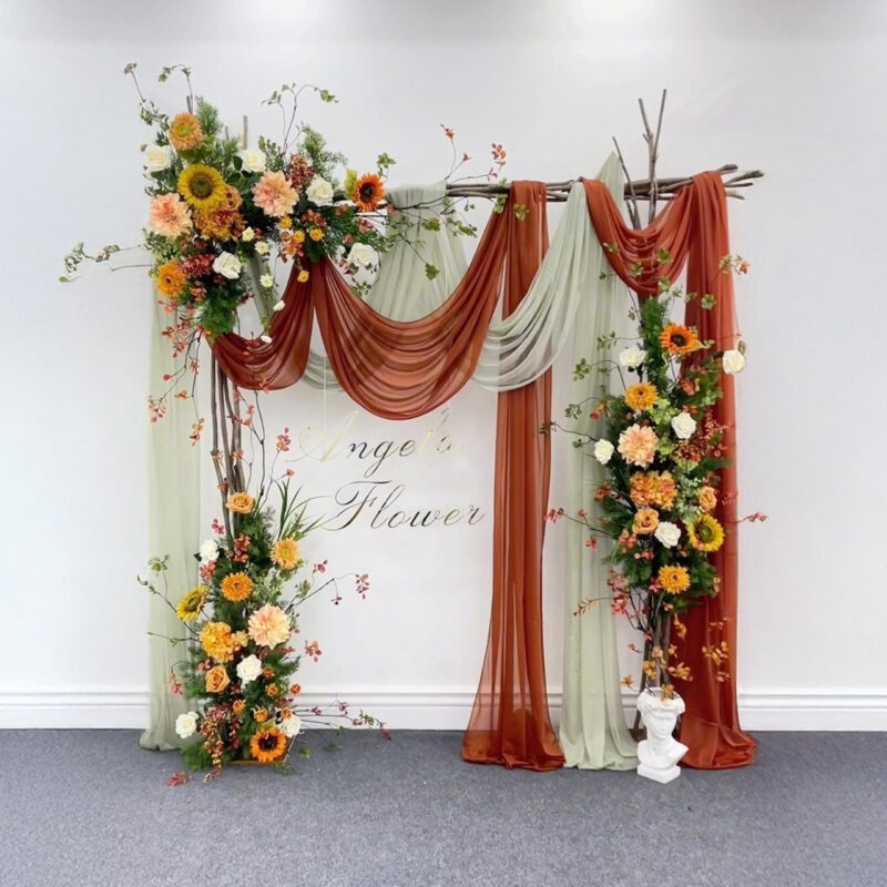 Wooden Wedding Arch with Boho Style and Warm Floral Clusters and Draped Ribbons